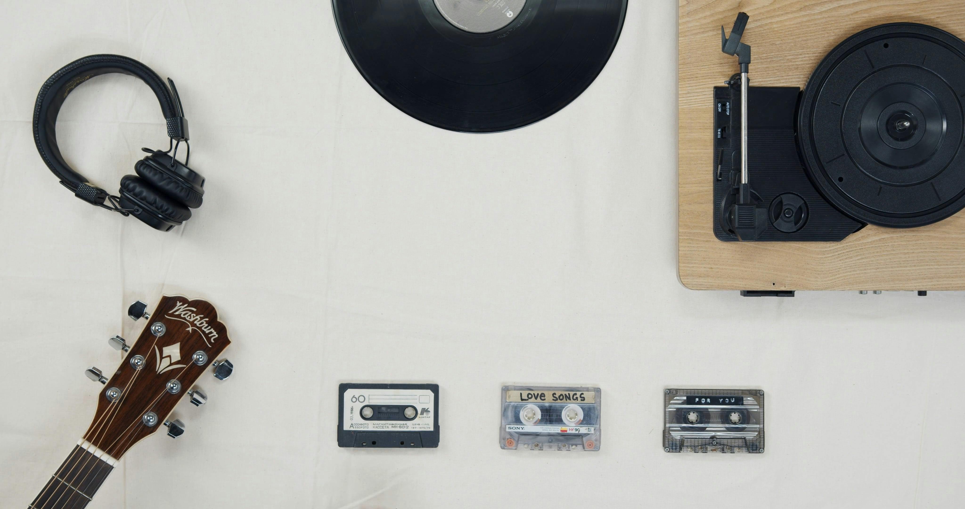 Arranging Music Related Items Over A White Surface · Free Stock Video