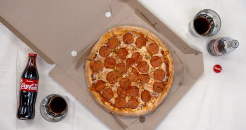 A Meal Of Coke And Pepperoni Pizza