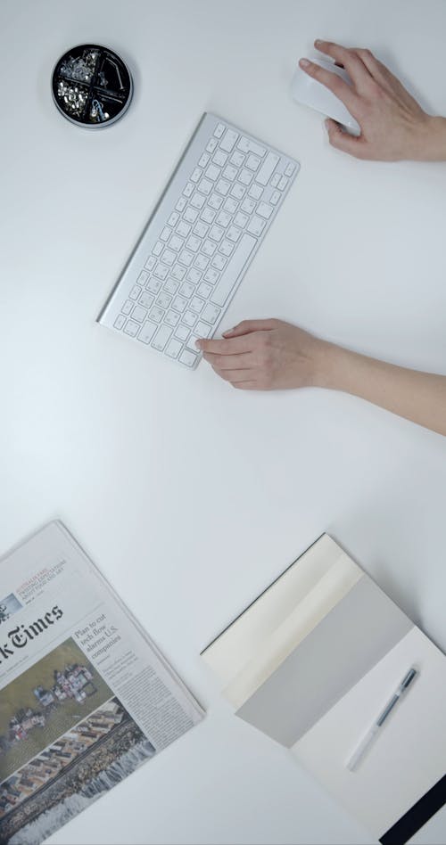 A Person Using A Wireless Keypad And Mouse 