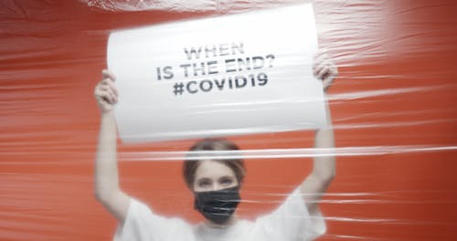 A Woman Asking Through A Signboard "When Will Covid19 End"