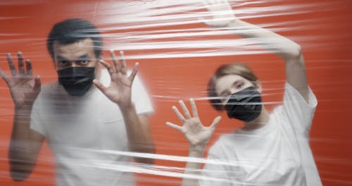 A Couple In Quarantine Inside An Isolation Area Sealed With Plastic