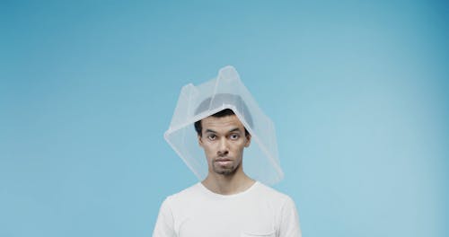 A Man Using Plastic Box To Cover His Head