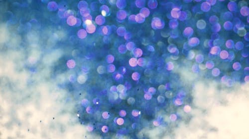 Close-Up of Falling Glitters in Liquid