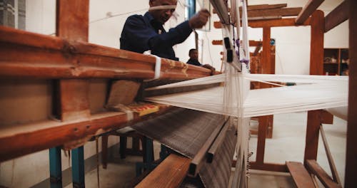 A Man Working As Weaver In A Textile Industry