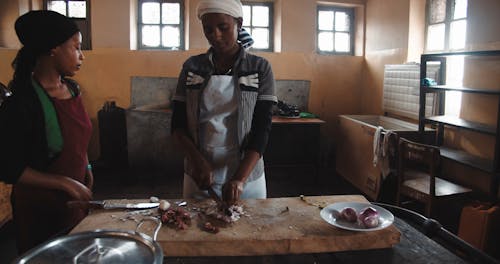 A Woman Chopping Ingredients Using Kitchen Knife