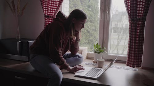 Woman Using Laptop at Home