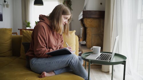 Woman Writing On A Notebook