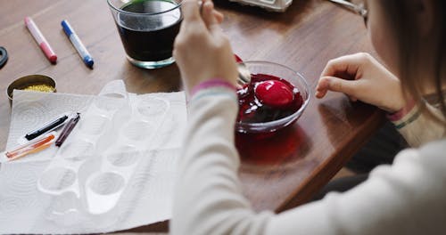 Soaking An Egg On A Bowl Of Red Dye Coloring