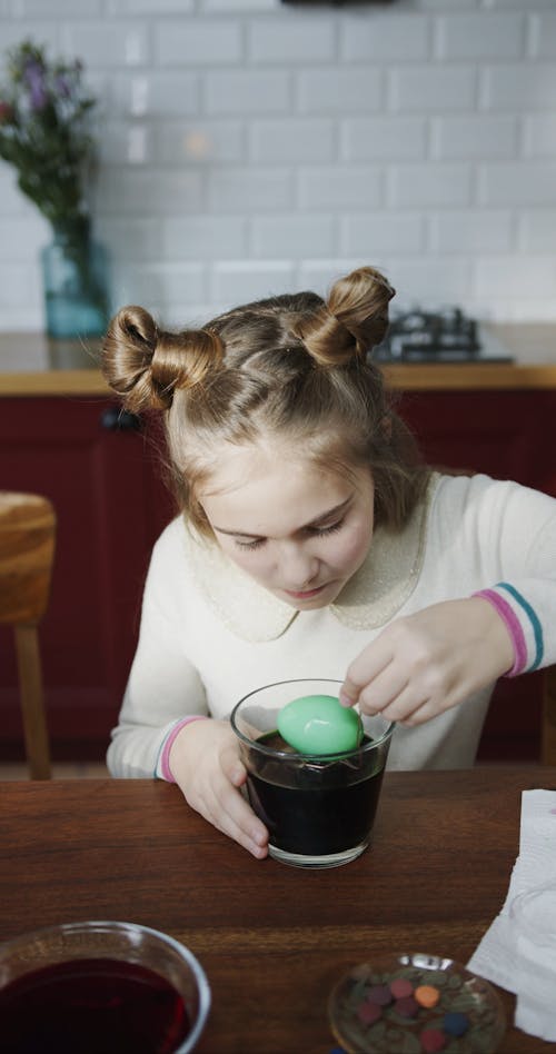 Scooping Out Egg From A Bowl Of Color Green Liquid Dye