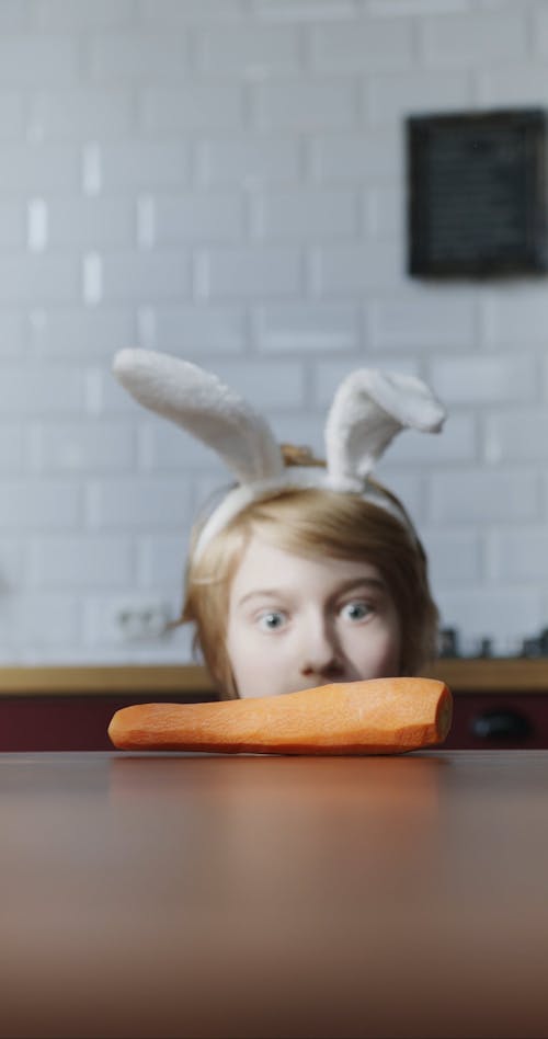 A Boy Having A Bite Of Fresh Peeled Carrot