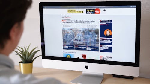 A Woman Using The Computer To Get News About The Corona Virus