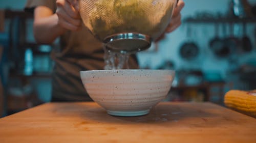 A Person Making A Dish Of Fresh Vegetable Salad