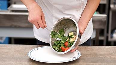 a chef preparing a fresh vegetable salad