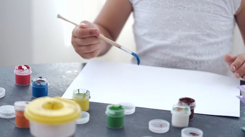 A Child Painting on Paper