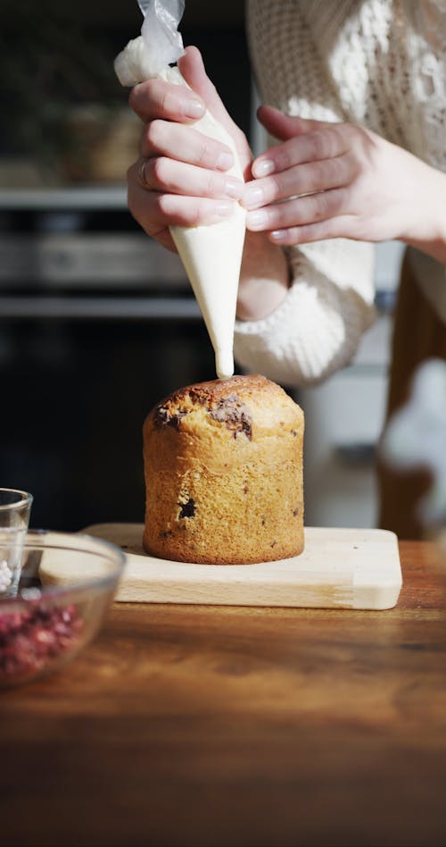 Putting Icing Cream On A Cake Using Piping Tube