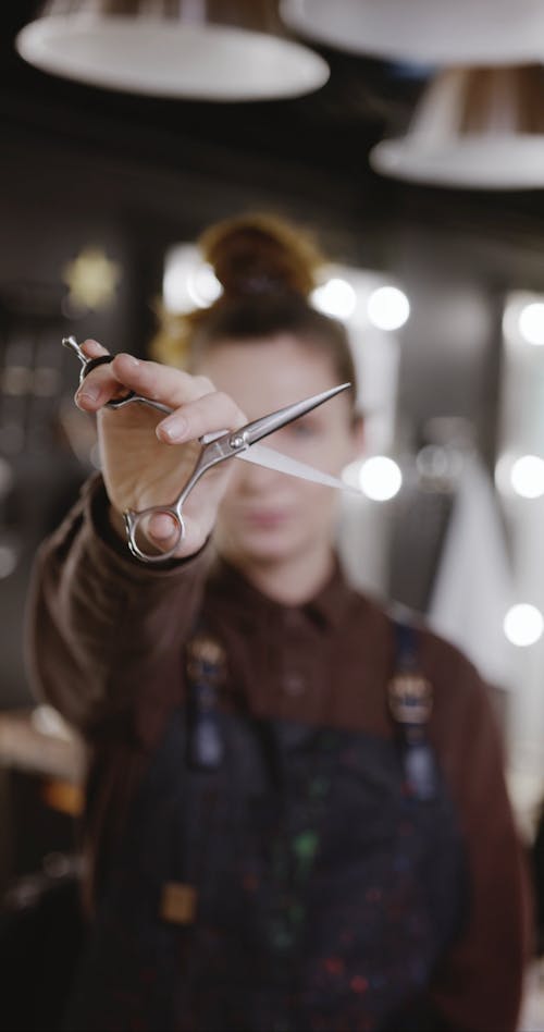 A Hairdresser Testing Her Scissor For Hair Cutting