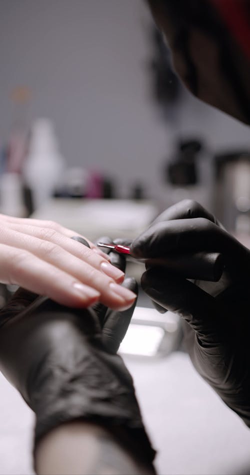 A Manicurist Using Automatic Nail Pusher Machine On A Client ...