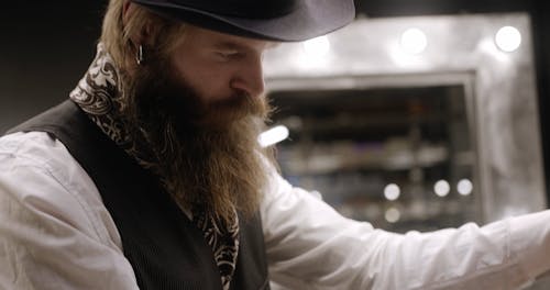 A Barber Using A Razor In Grooming A Man's Beard