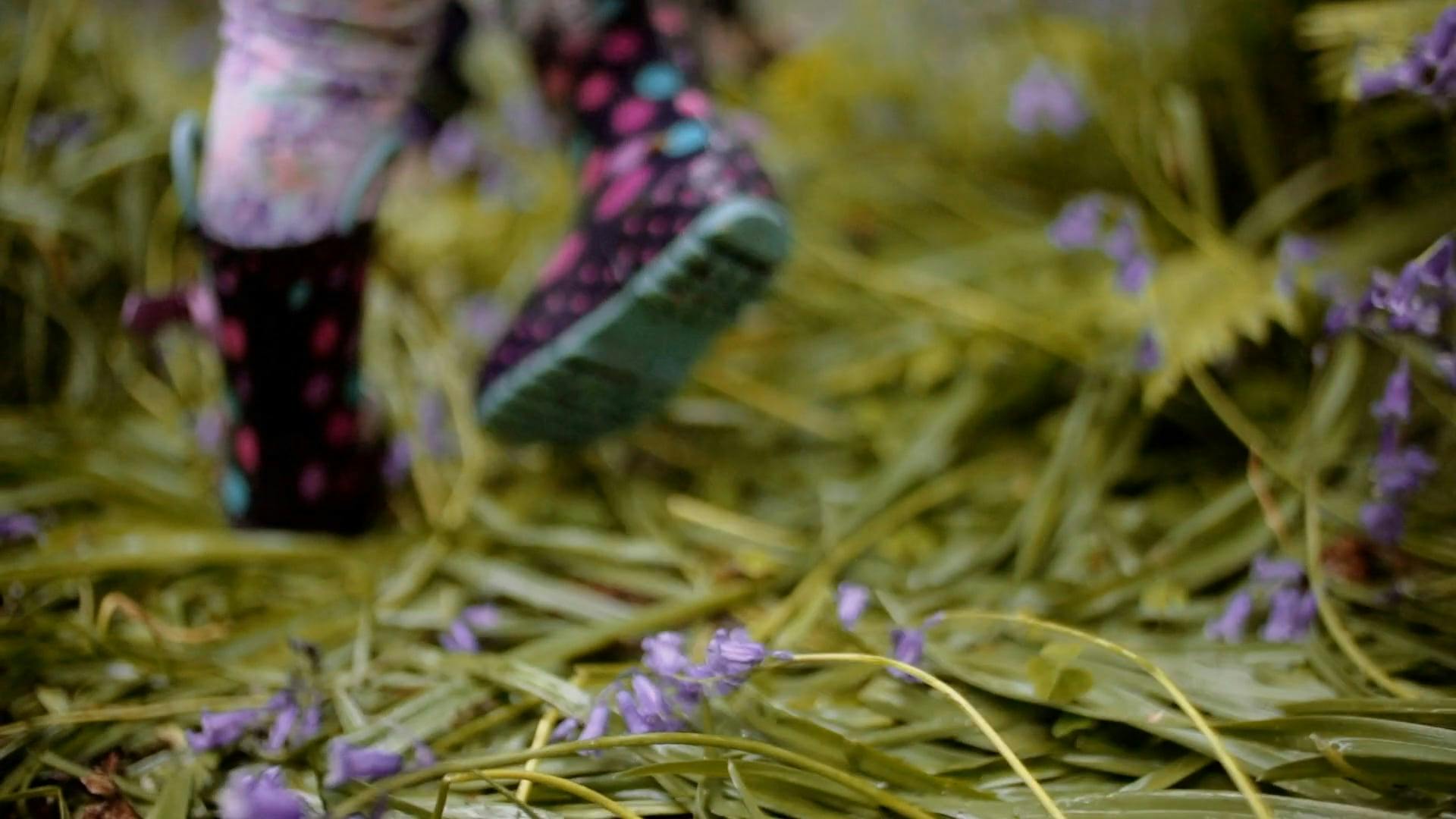 A Kid Walking On Wet Grasses Wearing Water Proof Boots · Free Stock Video