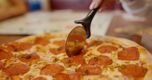 Slicing A Pizza With A Cutter