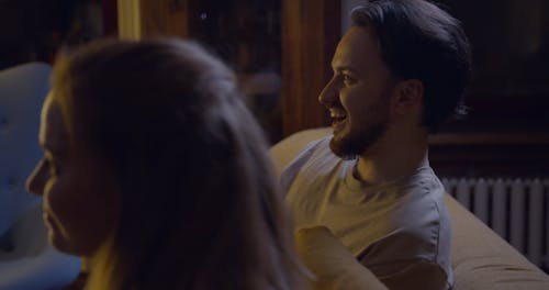 A Couple Playing A Game Using Remote Controls