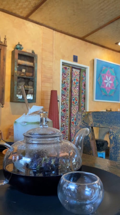 Pouring Blue Tea on a Glass Teacup