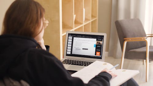 A Woman Studying Alone Using a Laptop