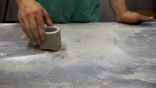 A Man Looking At A Concrete Cast Object