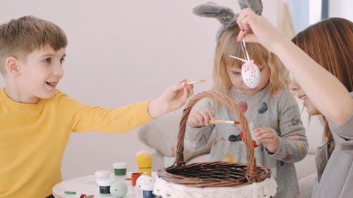 Woman and Kids Painting Easter Eggs