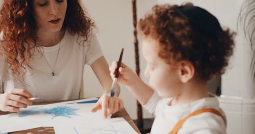 A Mother Teaching Her Child To Paint