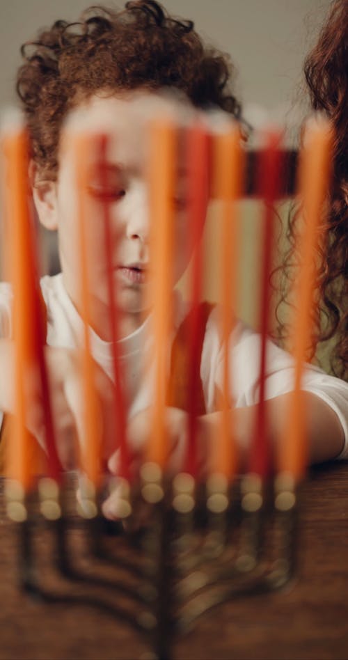 A Little Boy Playing With A Star Of David Top Toy