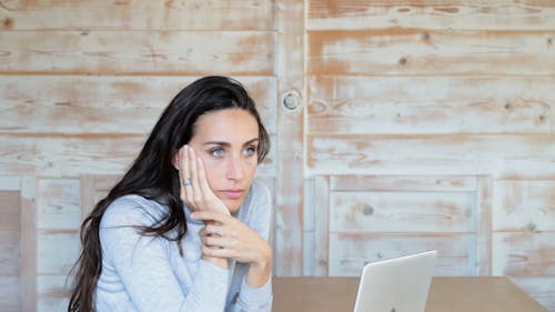 A Woman Thinks Before Closing The Laptop