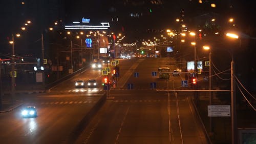 Street at Night with Lots of Cars Passing By