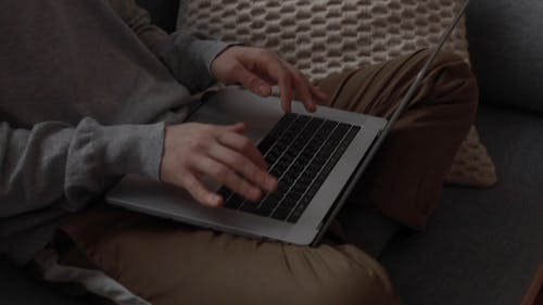 Person Typing On A Laptop