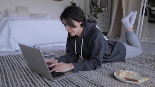 A Woman Typing on a Laptop Keyboard 
