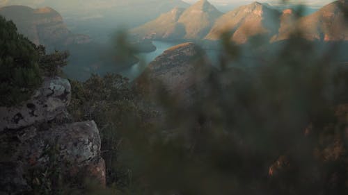 A Woman Sitting on the Edge of a Cliff