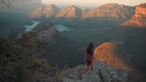 A Woman Standing on the Edge of a Cliff