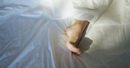 A Woman's Feet Stretching Her Toes In Cold