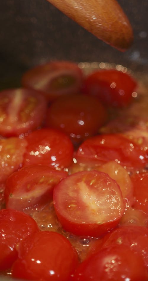 Sauteing Fresh Tomatoes On A Hot Pan Of Olive Oil