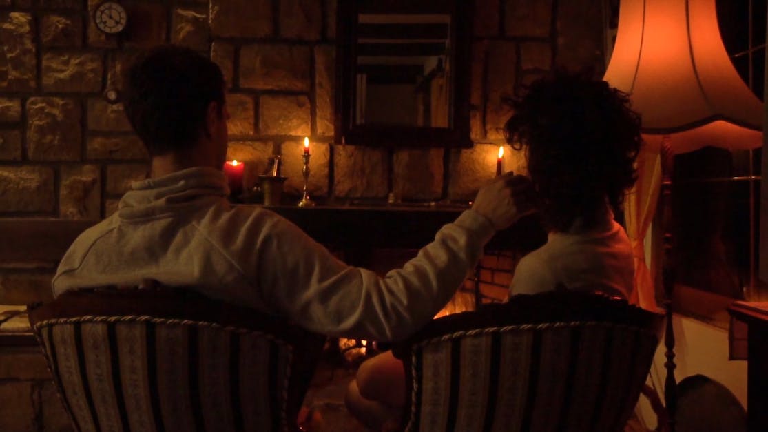 A Couple Sweet Moments Sitting In Front Of A Fireplace · Free Stock Video