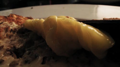 A Person Spreading a Butter on a Piece of Bread