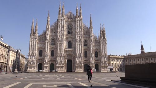 A Woman Walking Towards the Cathedral