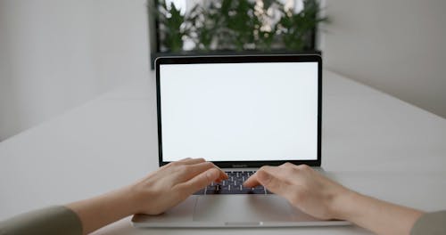 A Person Using A Macbook Pro Laptop