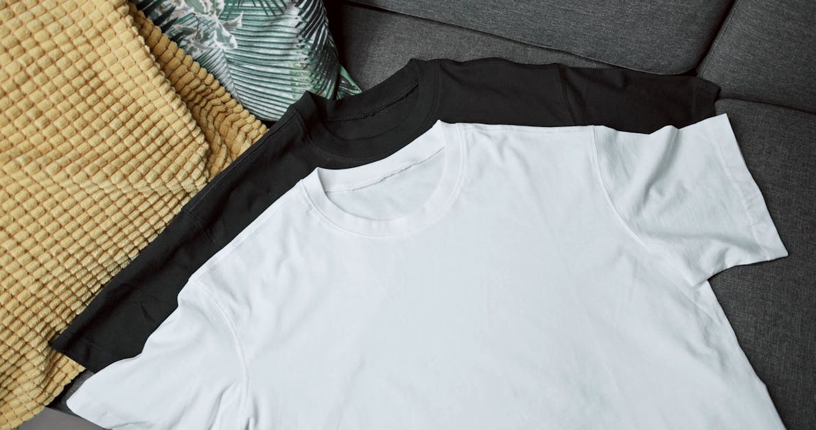A Black And White Crew T-shirts Lying On A Couch · Free Stock Video