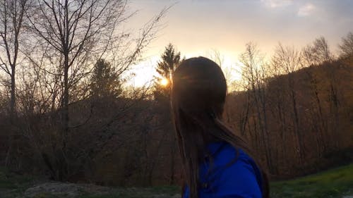 A Woman Enjoying The Sunset View While Walking