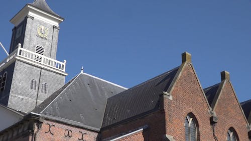 Low Angle Photography Of A Church Tower And Roofing