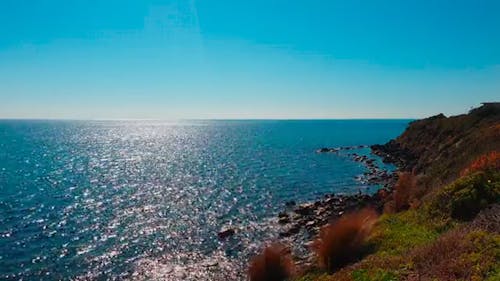 Blue Water Of The Sea Kisses The Rocky Coastline