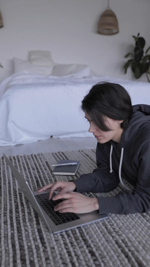 A Woman Typing on her Laptop