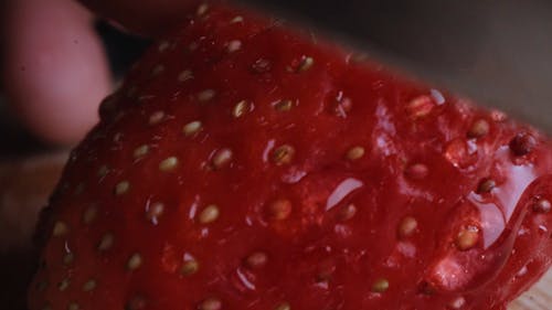 Close Footage Of Slicing a Strawberry Fruit