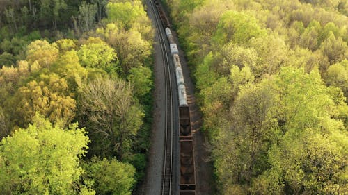 Long Cargo Freight Trains Transferring Goods Across Mountains